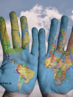This image shows hands with a map of the world painted onto them.