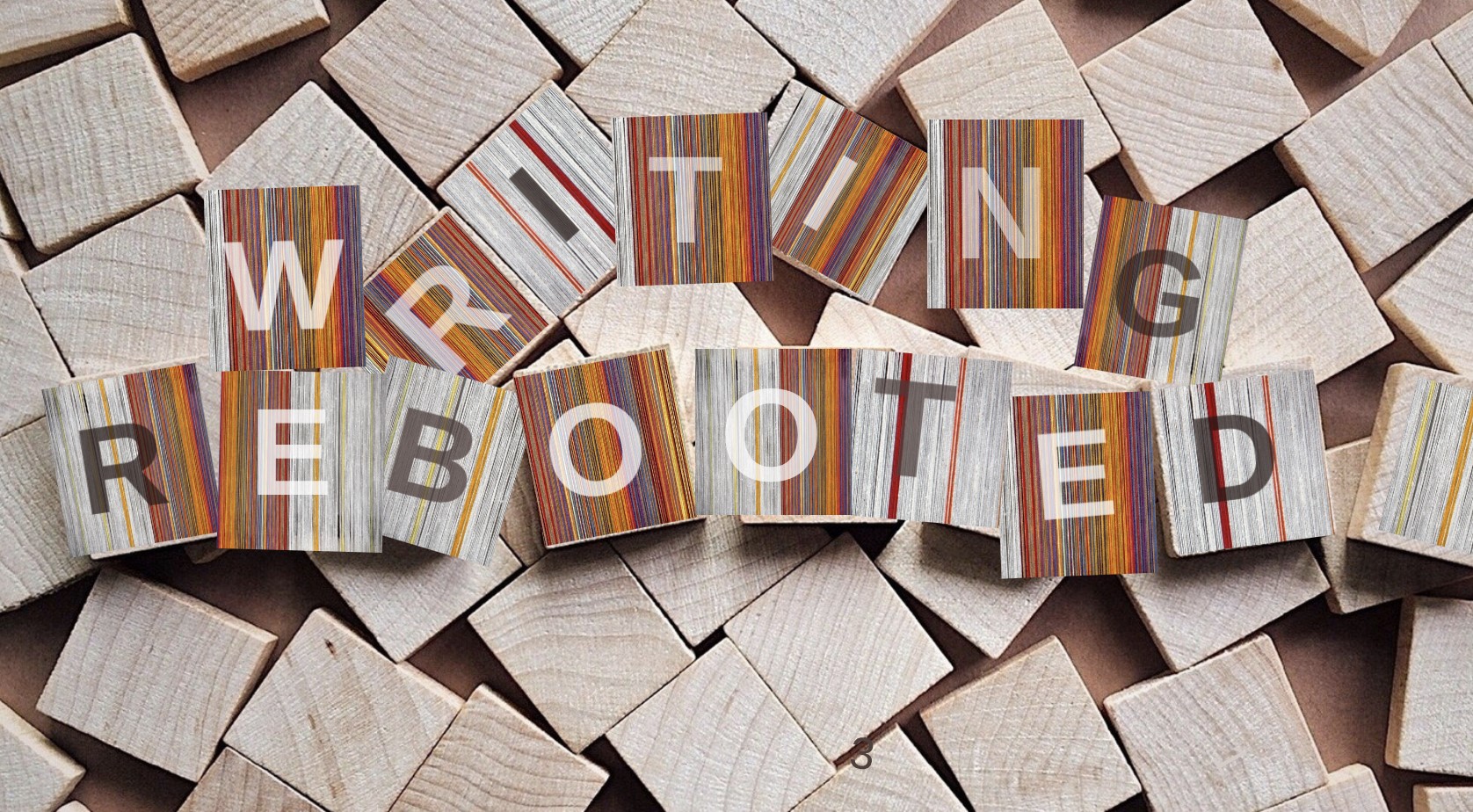 Wooden blocks with lettering spelling writing rebooted.