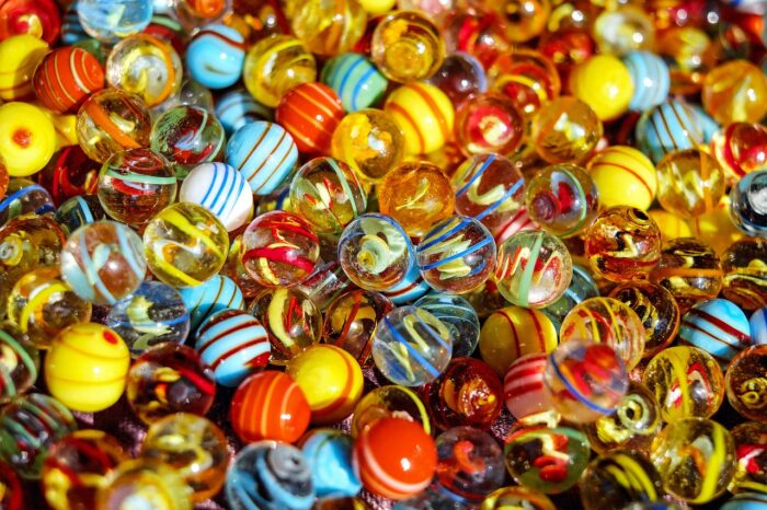 Hundreds of marbles of differing colours and patterns.